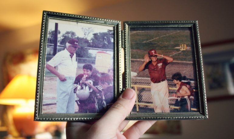 Person Holding Old Family Photos